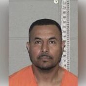 Mugshot Portrait: Inmate in Orange Jumpsuit