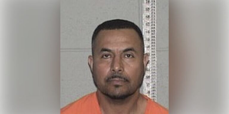 Mugshot Portrait: Inmate in Orange Jumpsuit