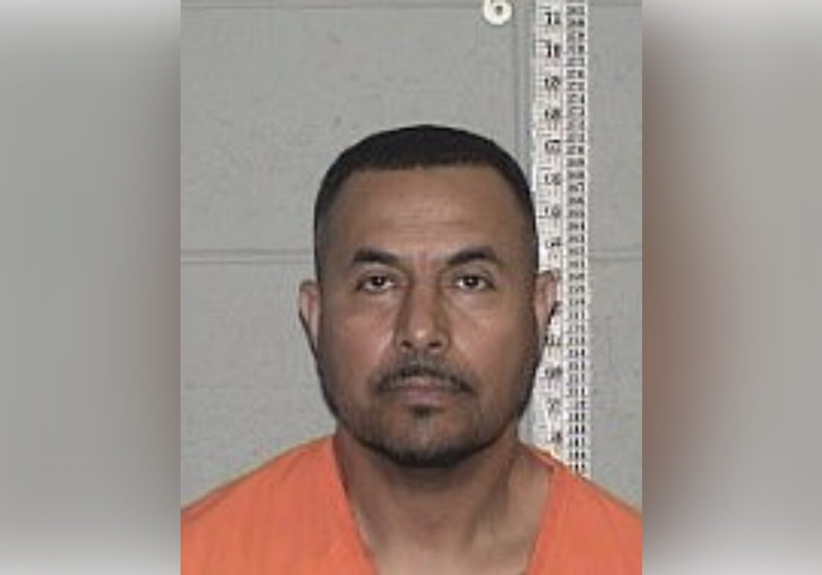 Mugshot Portrait: Inmate in Orange Jumpsuit