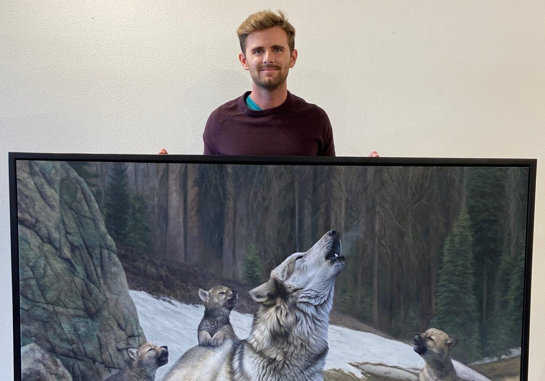 Man Showcases Wolf Family Painting Man Showcases Wolf Family Painting