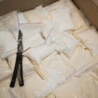Plastic bags with cocaine are in a cardboard package box Plastic bags with cocaine are in a cardboard package box