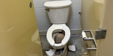 Broken Toilet in Bathroom Stall