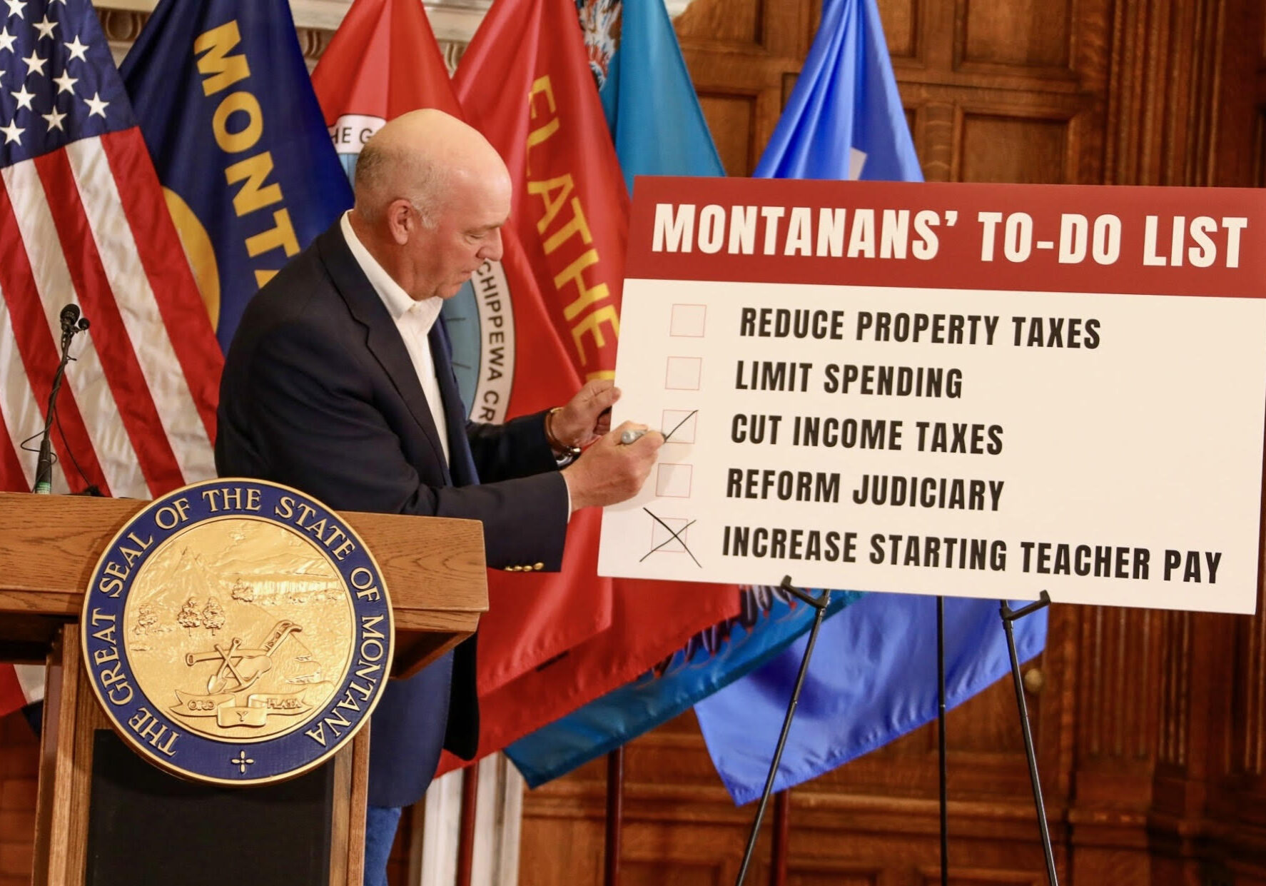 Montana Governor Greg Gianforte checks off income tax cuts and increased teacher spending legislative priorities on Montanan's To-Do List
