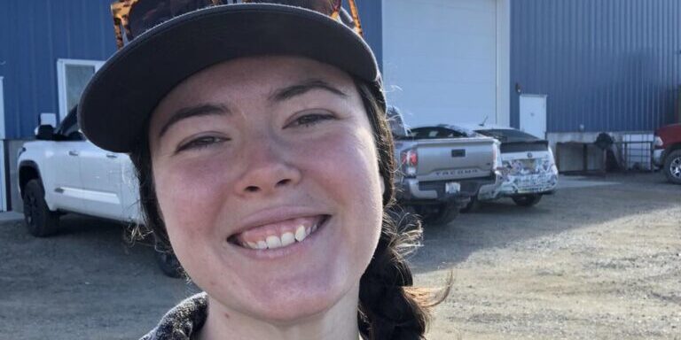 Outdoor Smiling Portrait in Front of Industrial Warehouse