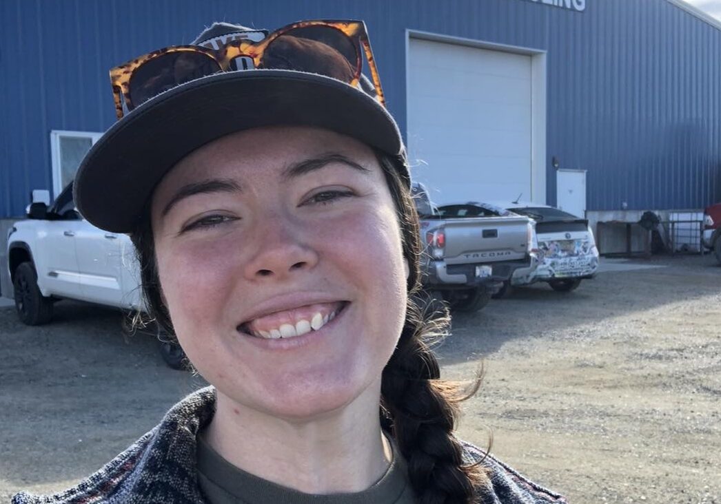 Outdoor Smiling Portrait in Front of Industrial Warehouse