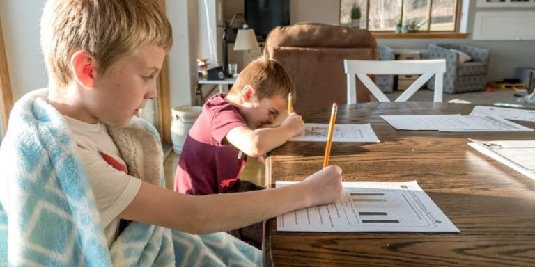 Homework at Home: Siblings Focused on Worksheets