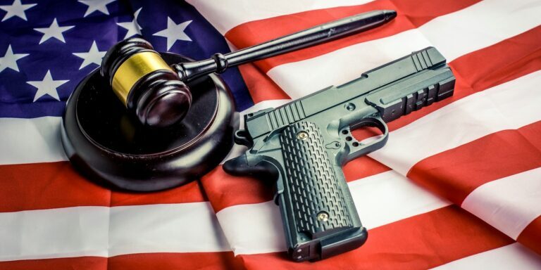 a gun, a judge's hammer, and an american flag