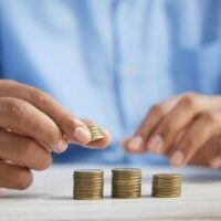 Photo by Towfiqu barbhuiya a person stacking coins on top of a table