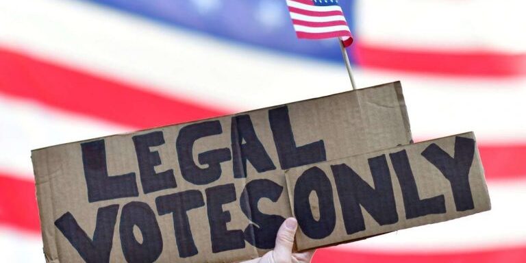 A GOP voter holds a placard reading "legal votes only" outside a ballot counting center in Philadelphia on November 8, 2020.