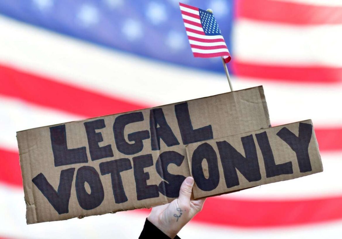 A GOP voter holds a placard reading "legal votes only" outside a ballot counting center in Philadelphia on November 8, 2020.