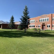 Historic School Building with Scenic Mountain Backdrop
