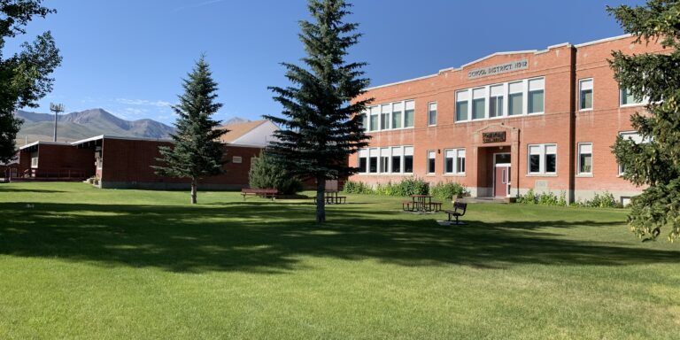 Historic School Building with Scenic Mountain Backdrop
