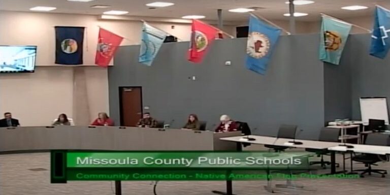 Indigenous National flags hang over Missoula school board trustees during their April 26, 2022 meeting.