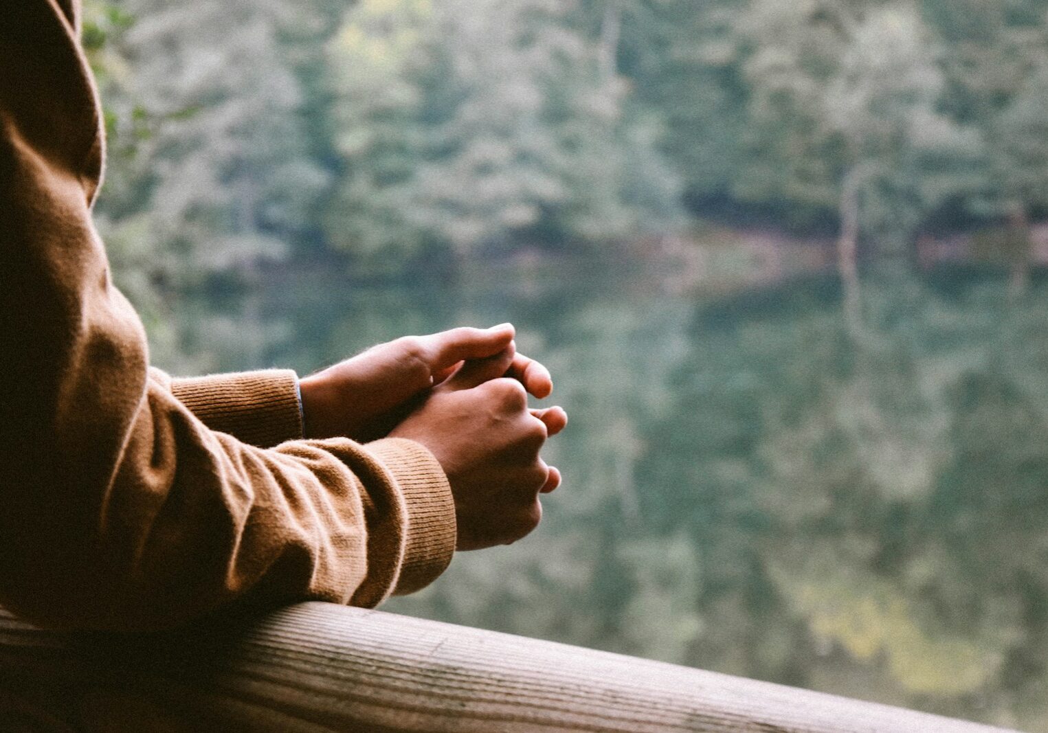 tilt-shift photography of person in brown jacket