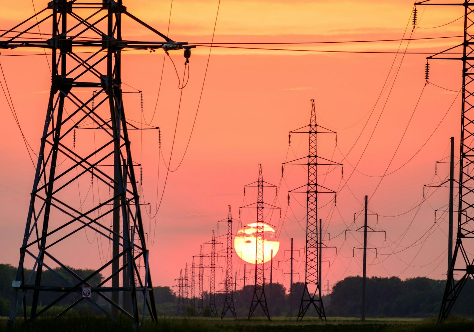 silhouette of electric post during sunset