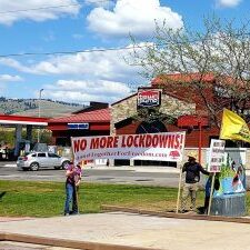 Stand Together For Freedom banner reads "NO MORE LOCKDOWNS!" Stand Together For Freedom banner at North East corner of North Reserve and Mullan.