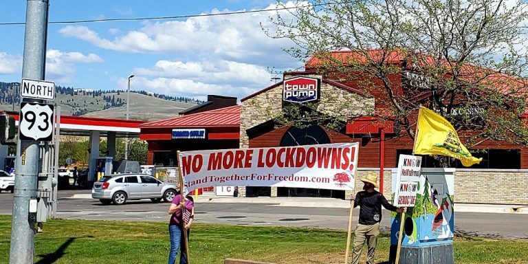 Stand Together For Freedom banner at North East corner of North Reserve and Mullan.