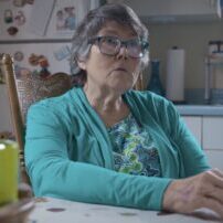 Elderly Woman in a Bright Kitchen Setting