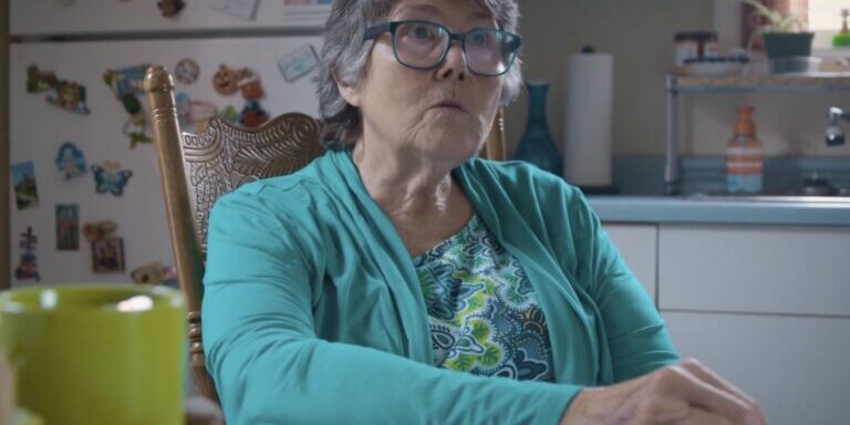 Elderly Woman in a Bright Kitchen Setting
