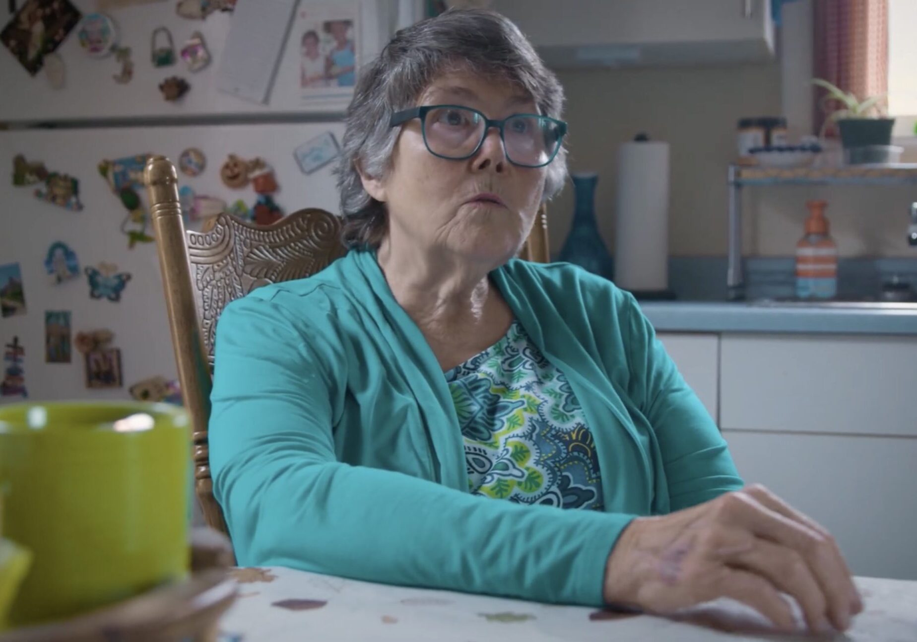 Elderly Woman in a Bright Kitchen Setting Elderly Woman in a Bright Kitchen Setting