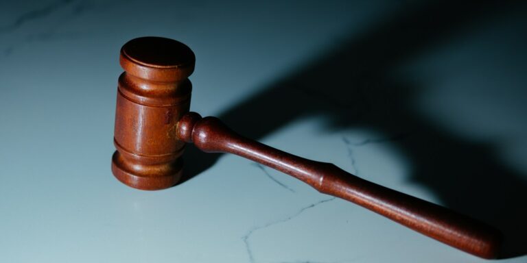 a wooden judge's hammer sitting on top of a table