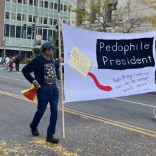 Protest Banner at Street Parade Addressing Political Controversy