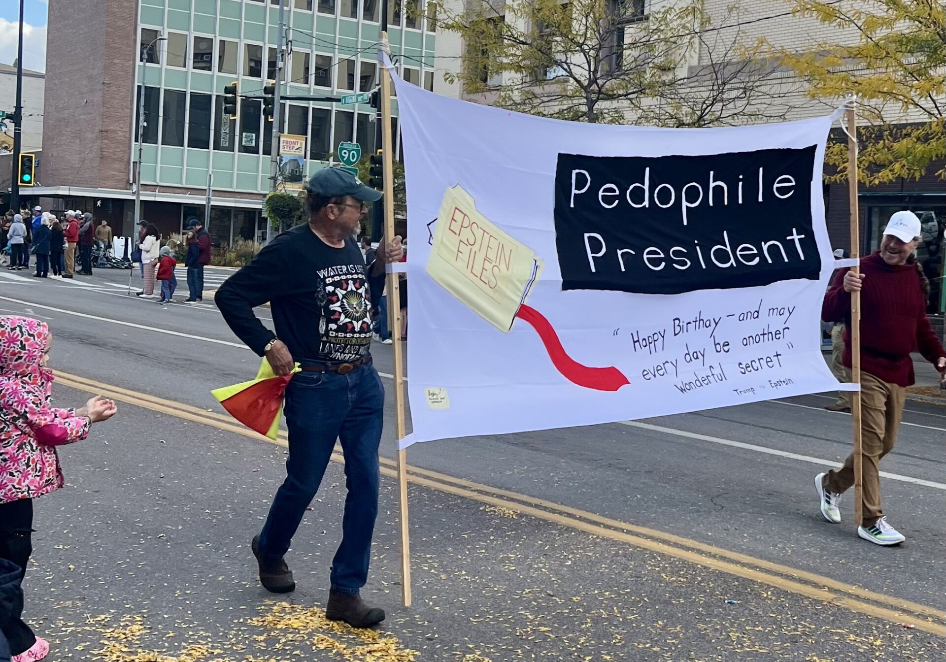 Protest Banner at Street Parade Addressing Political Controversy