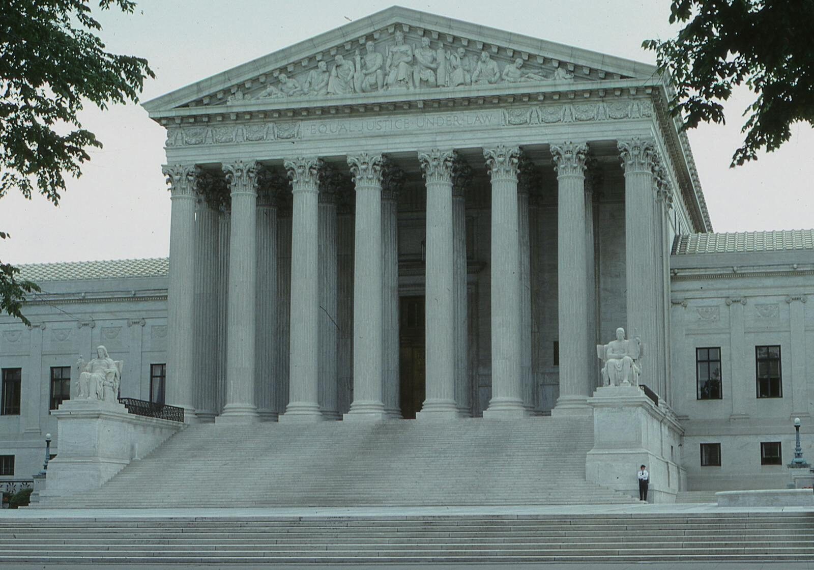 Photo by Malcolm Hill Front view of the iconic Supreme Court building with classical columns and majestic architecture.