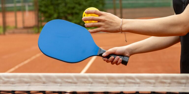 a person holding a tennis racket and a ball