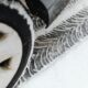 A detailed view of vehicle tire tracks on a snow-covered road during winter.