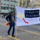 Protest Banner at Street Parade Addressing Political Controversy